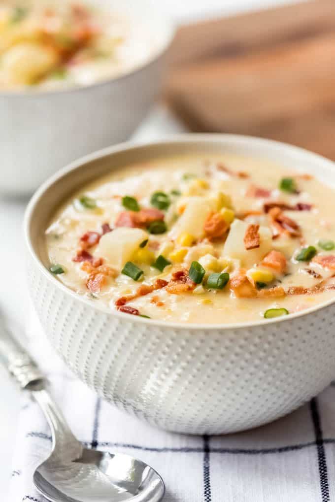 A bowl of corn chowder soup with bacon.