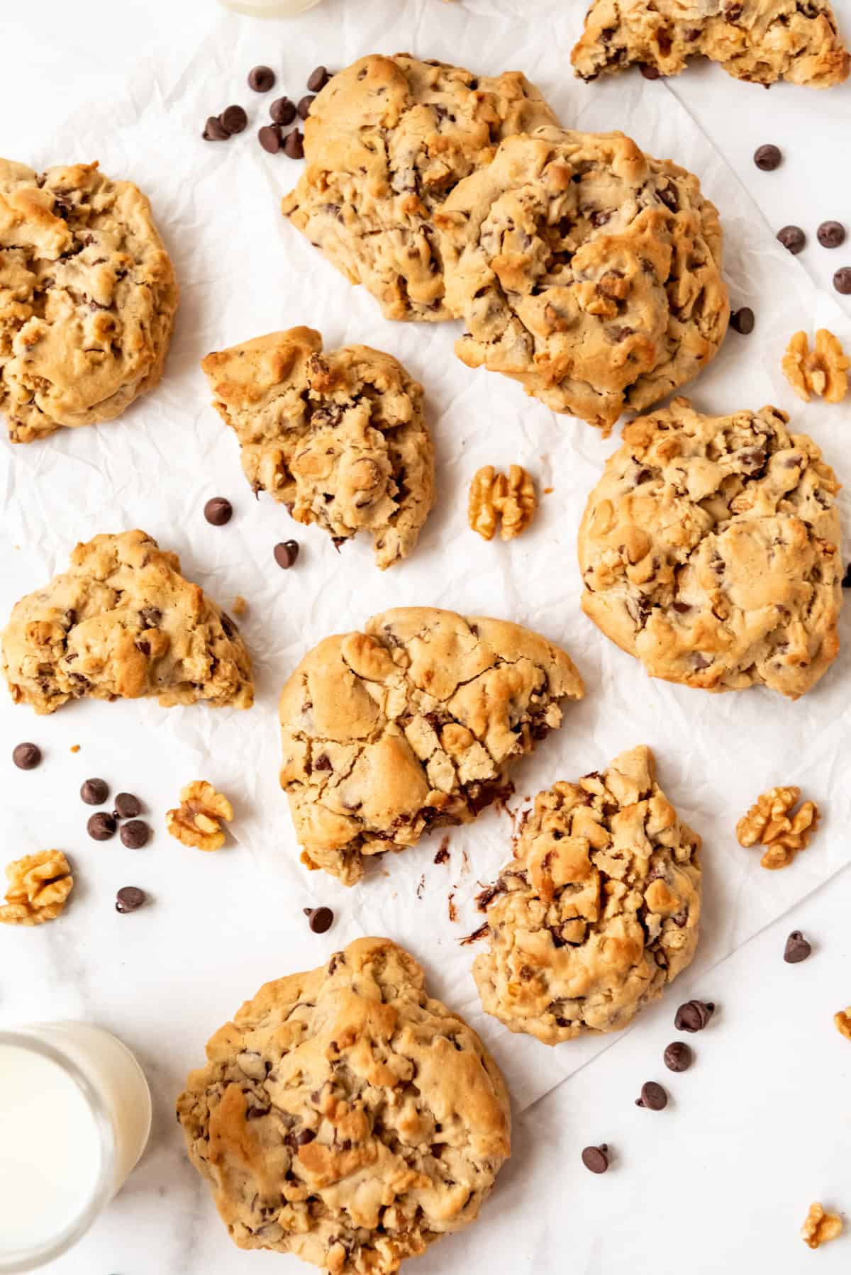 Levain chocolate chip cookies on baking paper with milk