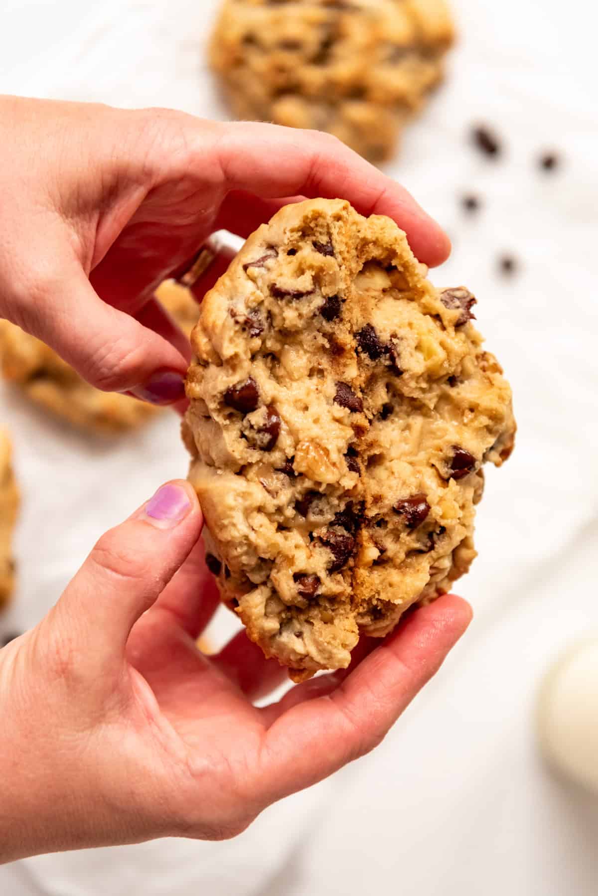 Hands holding Levain Chocolate Chip Cookies