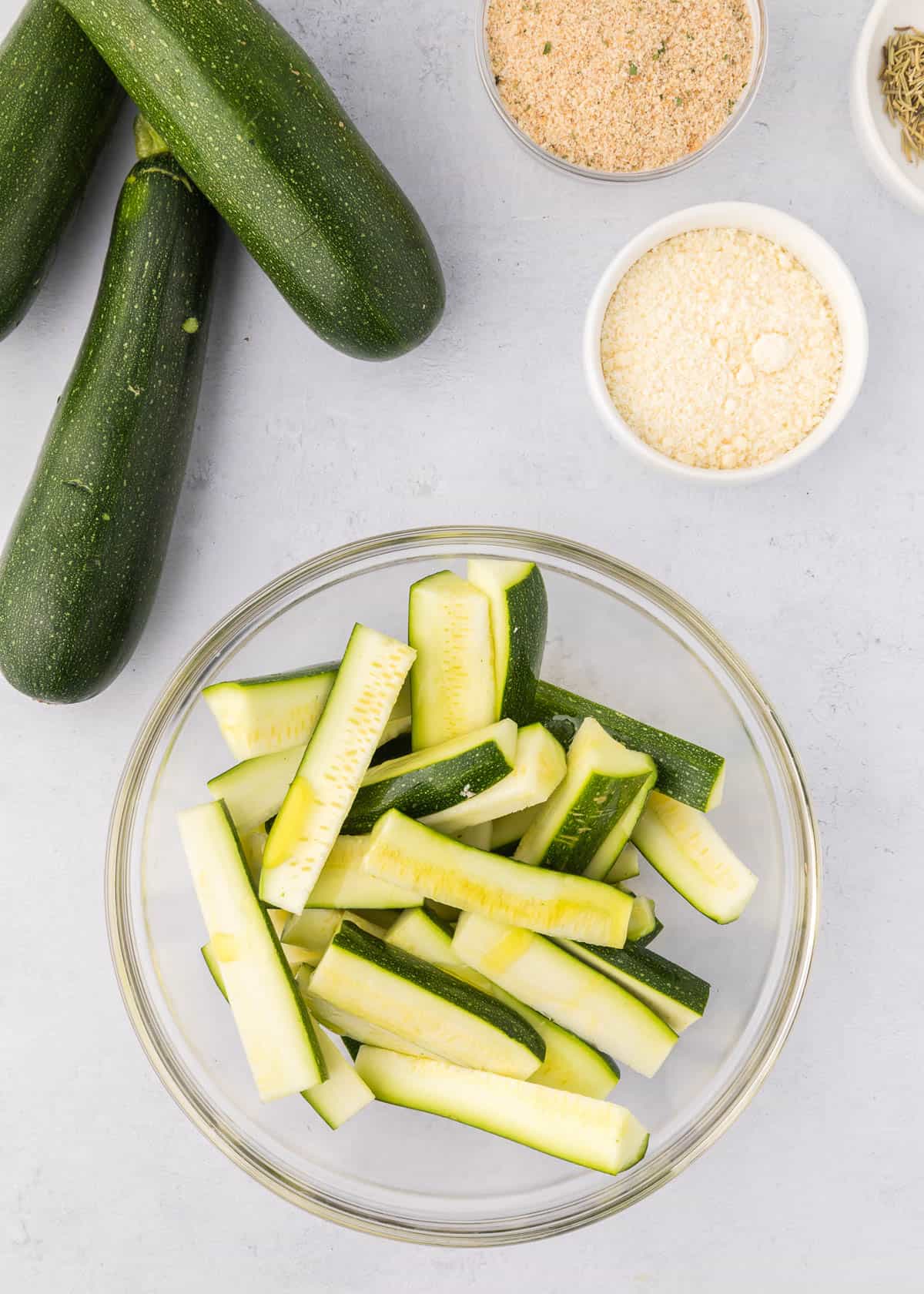 Sliced parmesan zucchini fries in a bowl.