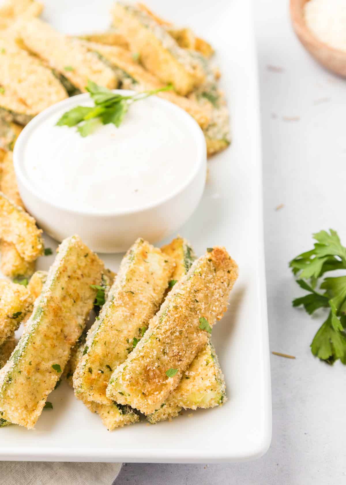 Crispy parmesan zucchini fries on a plate.