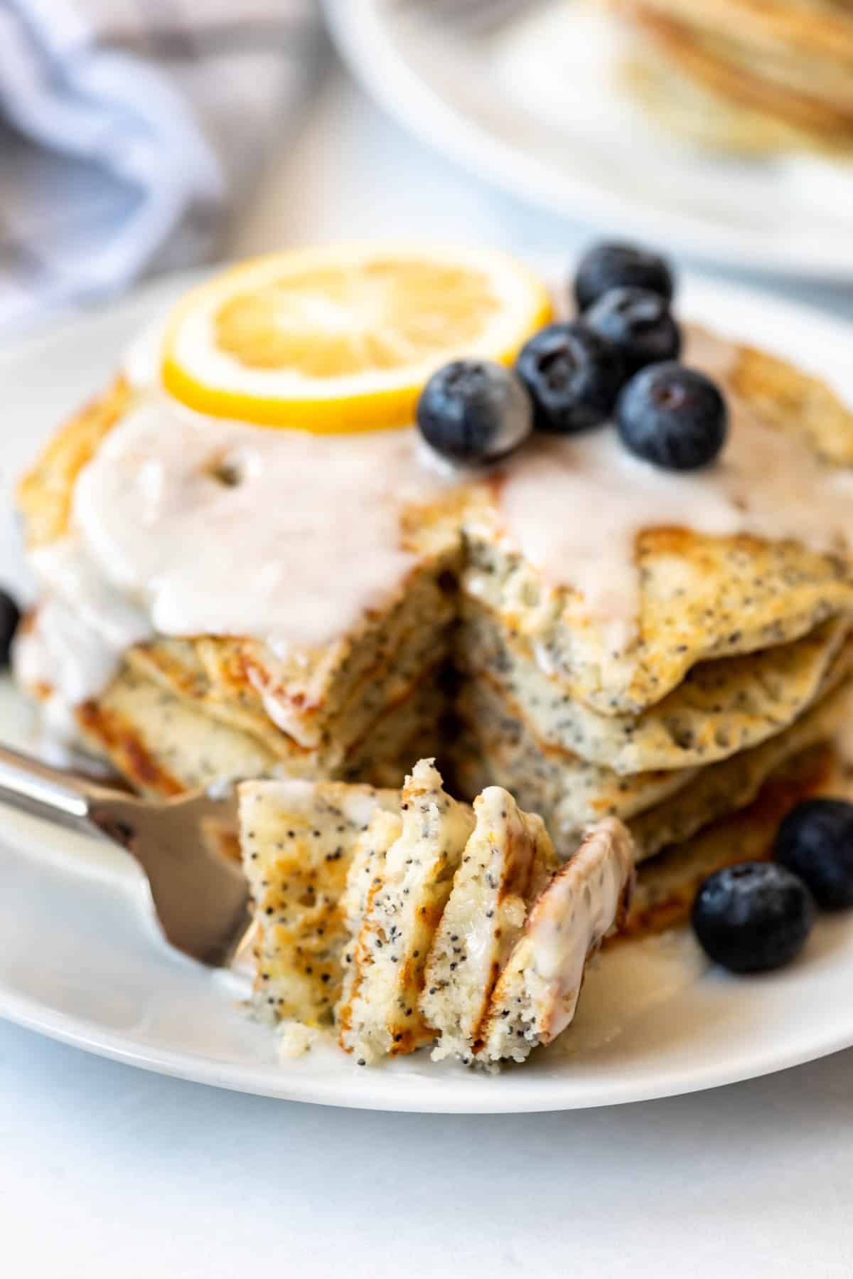 A bite of pancakes on a fork.