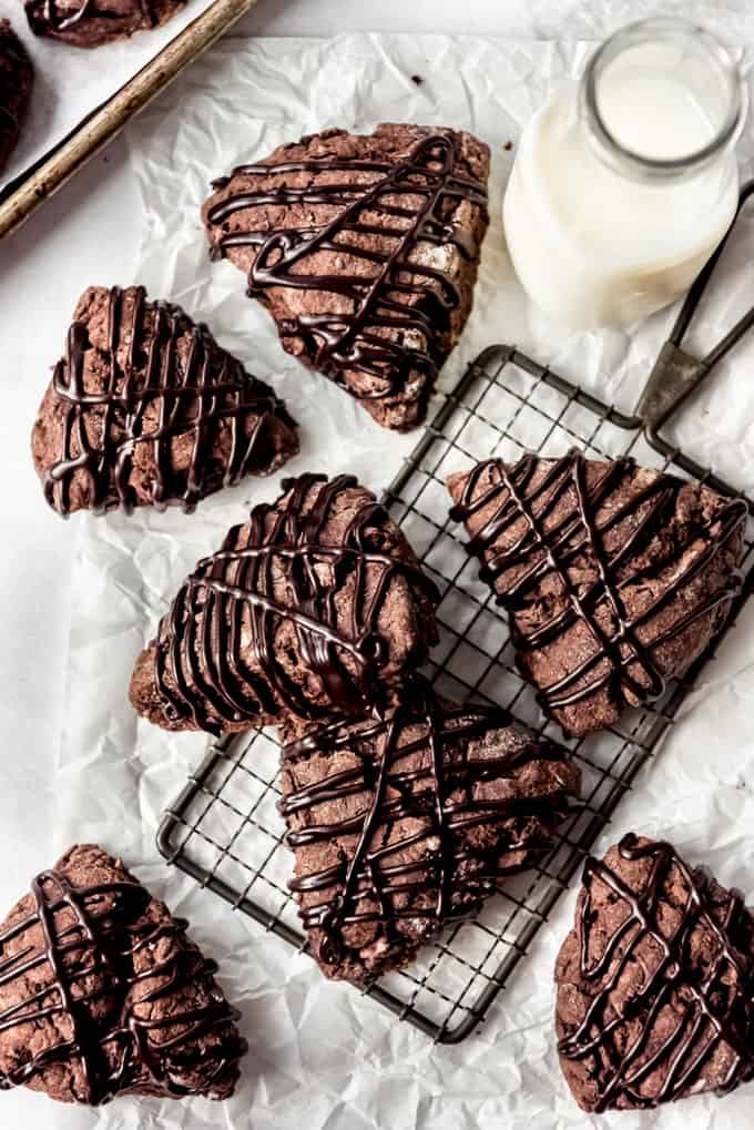 chocolate scones on a cooling rack and on paper table cover