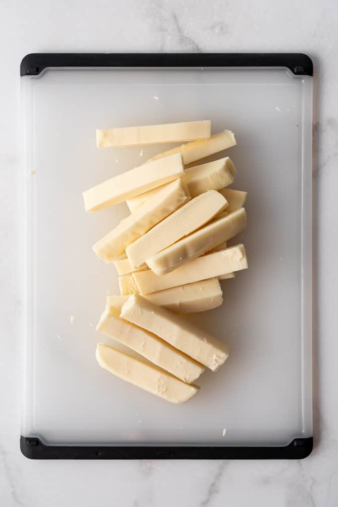 a block of low moisture mozzarella cheese sliced into sticks