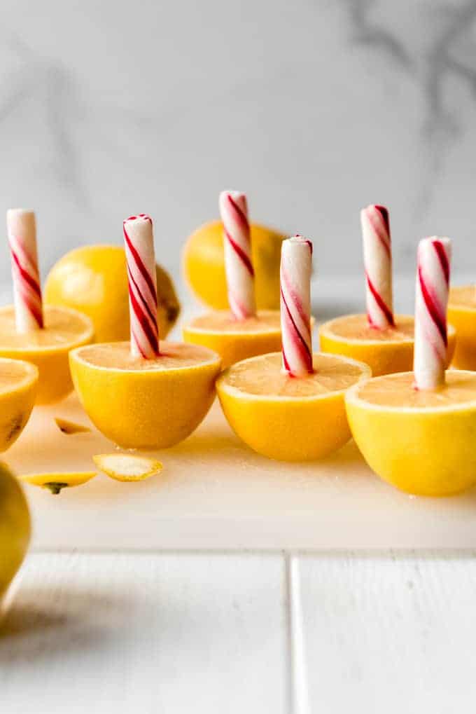 halved lemons with peppermint sticks stuck in them