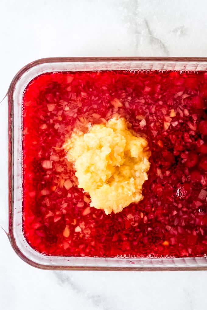 jello with cherries and pineapple, ready to set in the fridge