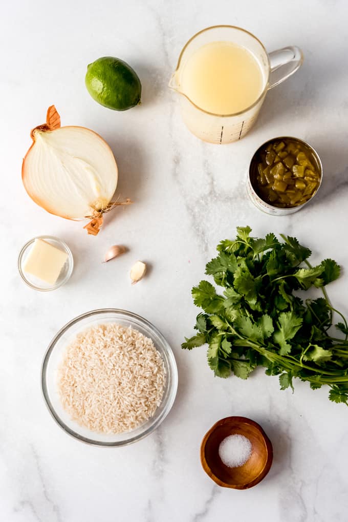 individual ingredients for cilantro lime rice on marble counter, overhead shot