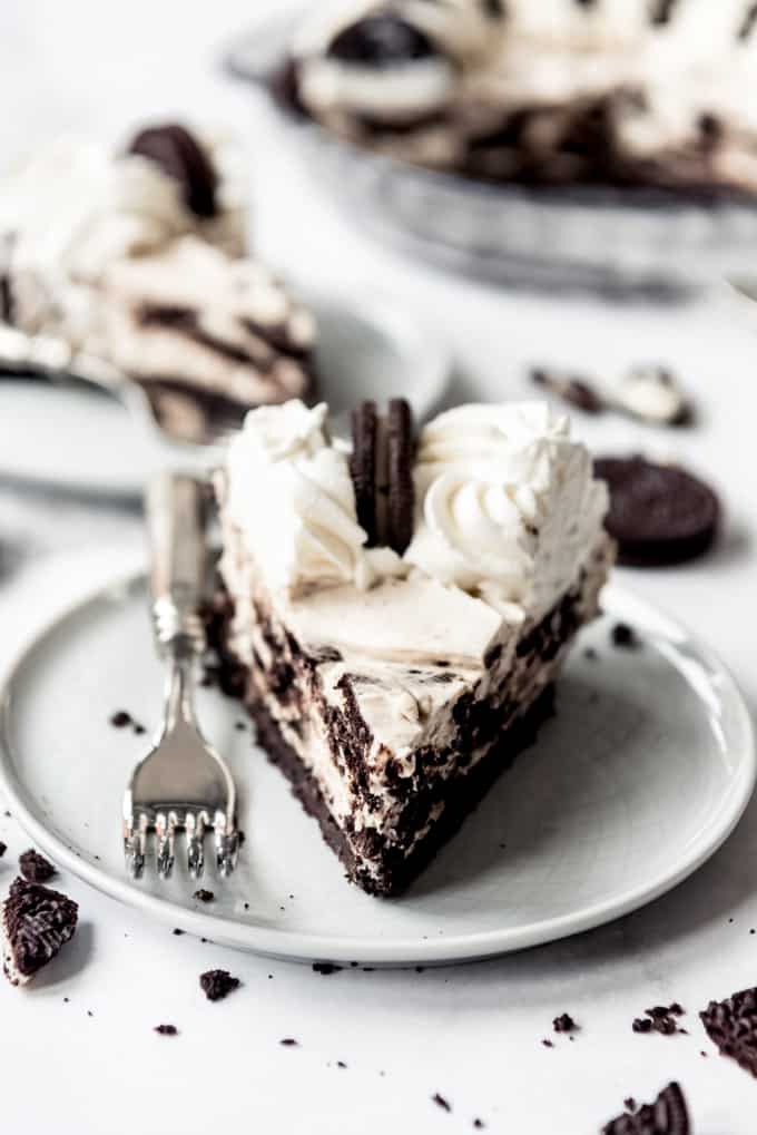 slice of oreo pie on white plate with fork.
