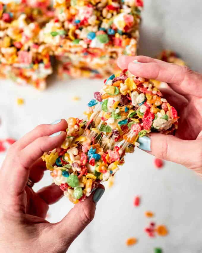 A soft rice krispie treat being pulled apart.