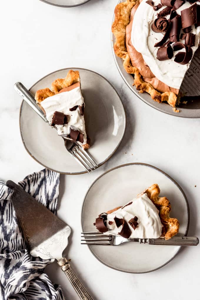 slices of chocolate mousse pie on plates with forks