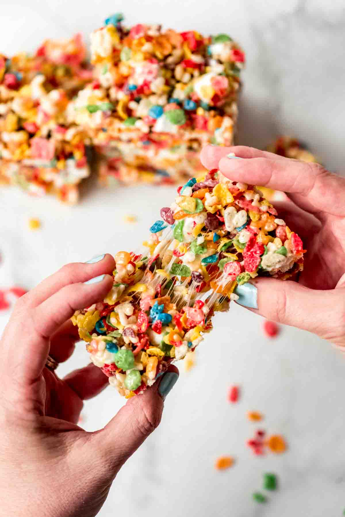 A soft rice krispie treat being pulled apart.