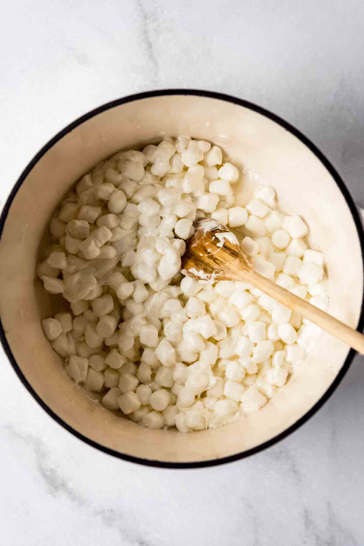 Melting marshmallows and butter in a large pot.