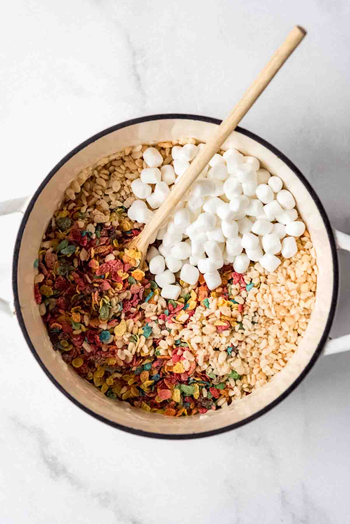 Marshmallows and cereal in a large pot.