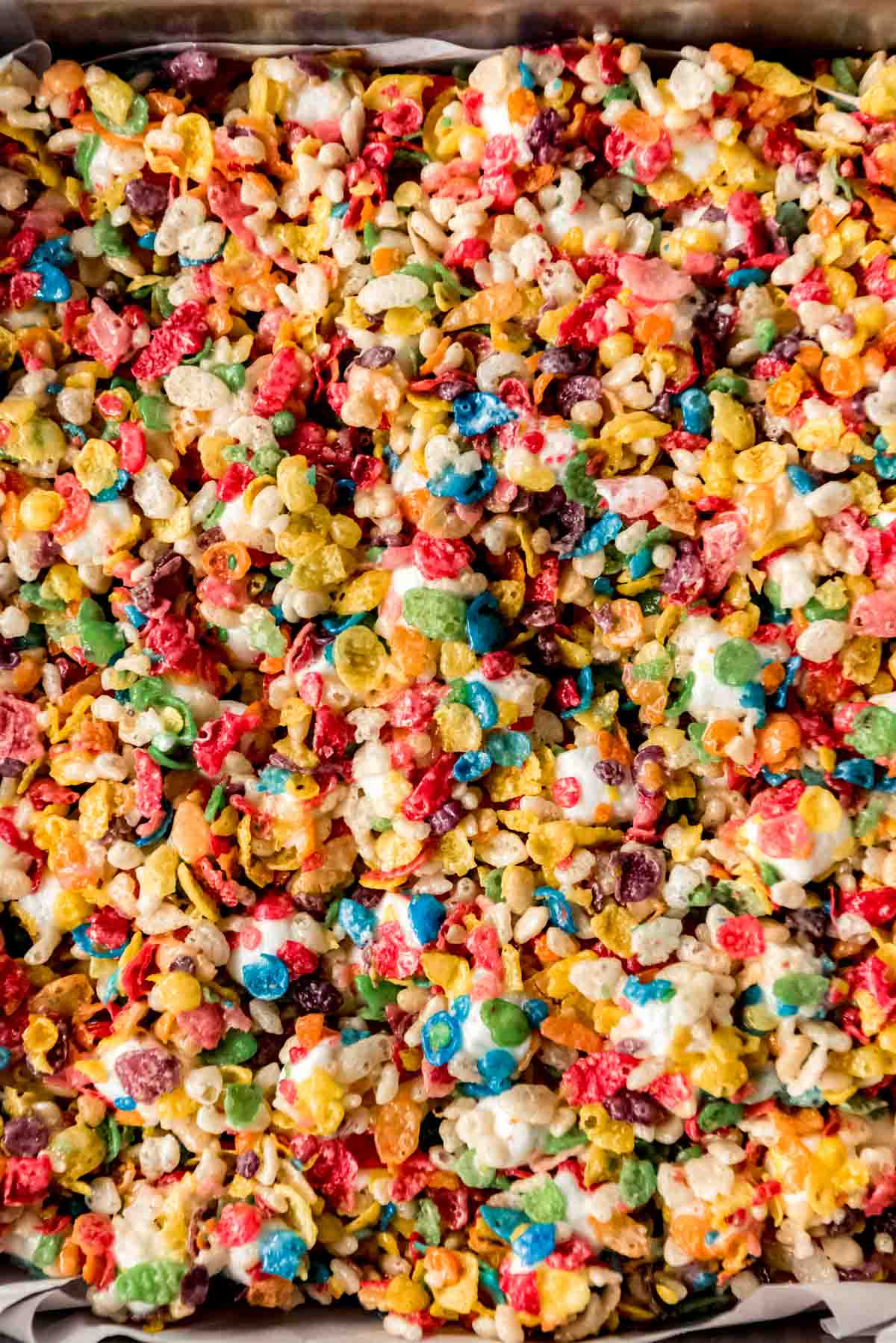 A close shot of the top of rice krispie treats made with fruity pebbles cereal.