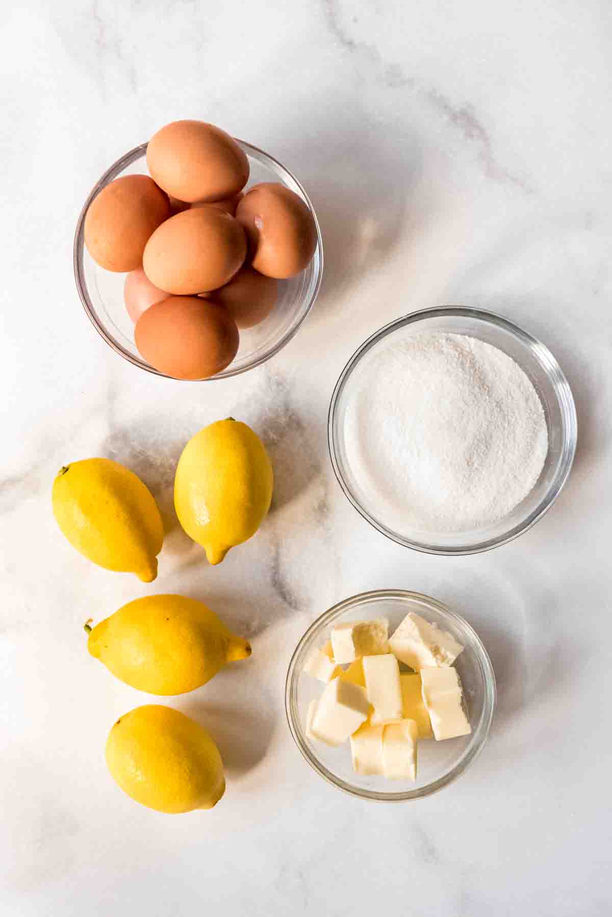 Eggs, sugar, lemons, and cubed butter.