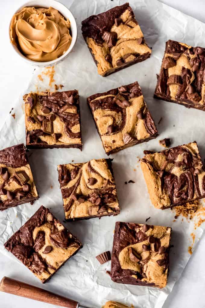 Individual slices of Peanut Butter Swirl Brownies on parchment paper, overhead shot