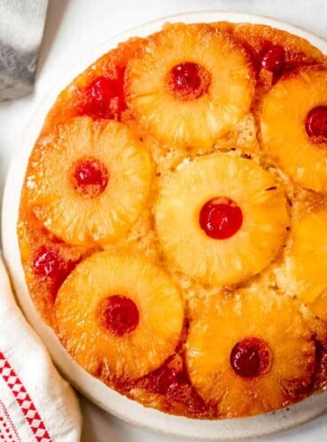 a from scratch pineapple upside down cake with pineapple and cherries