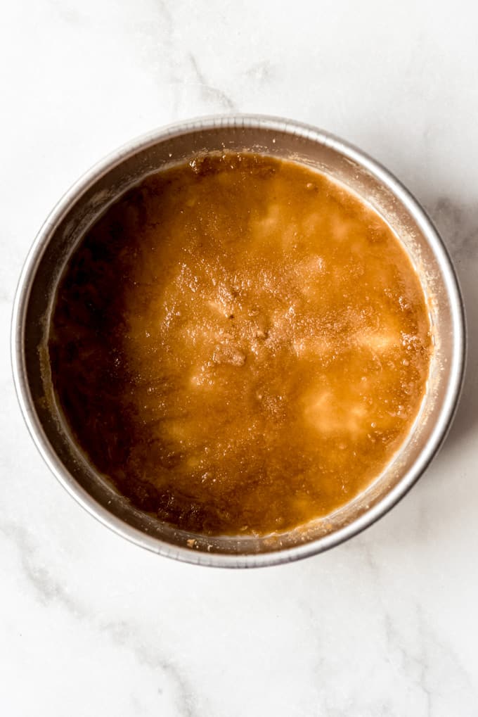 melted butter and brown sugar in the bottom of a cake pan