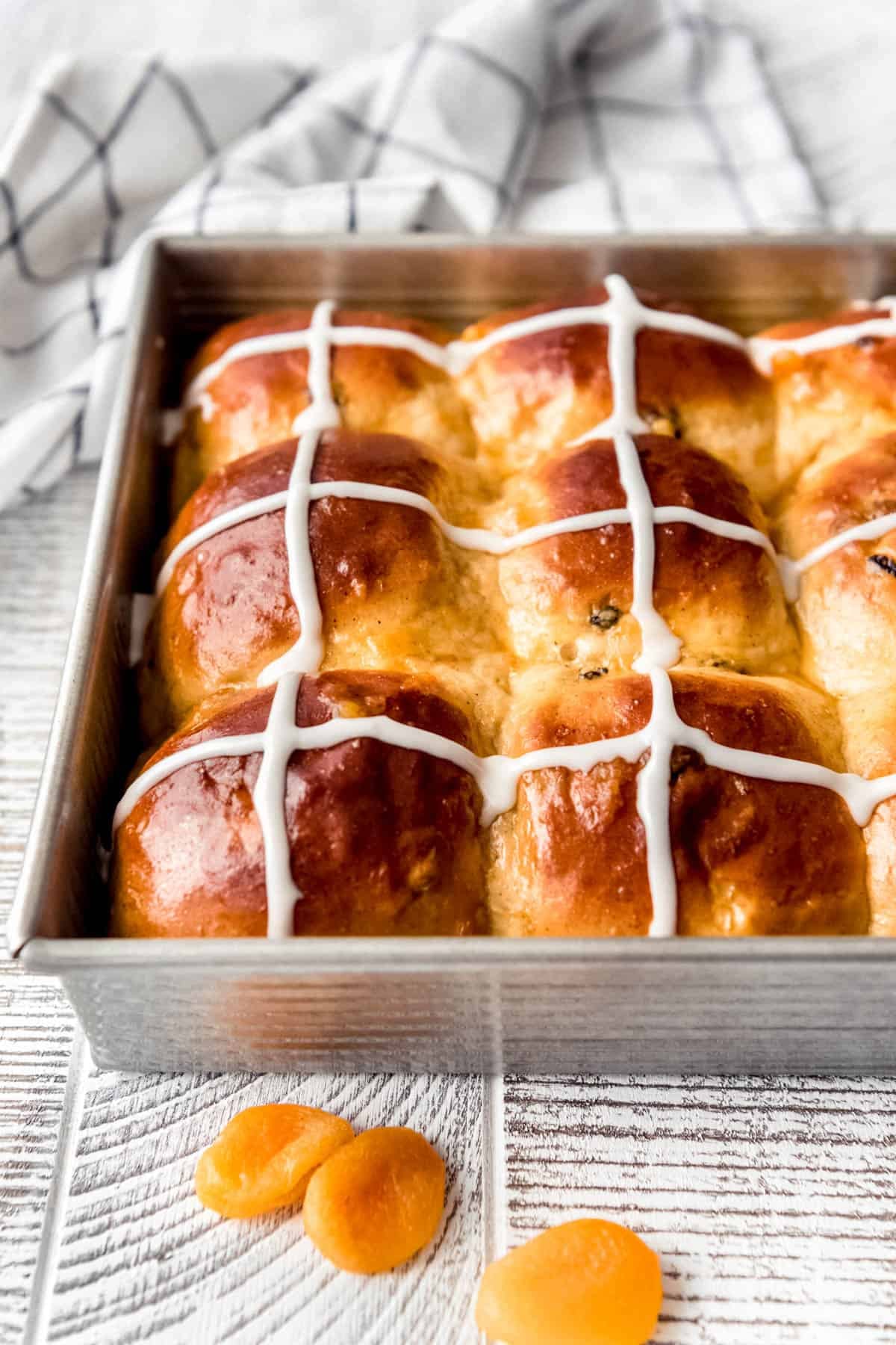 A side view of Easter hot cross buns in a pan.