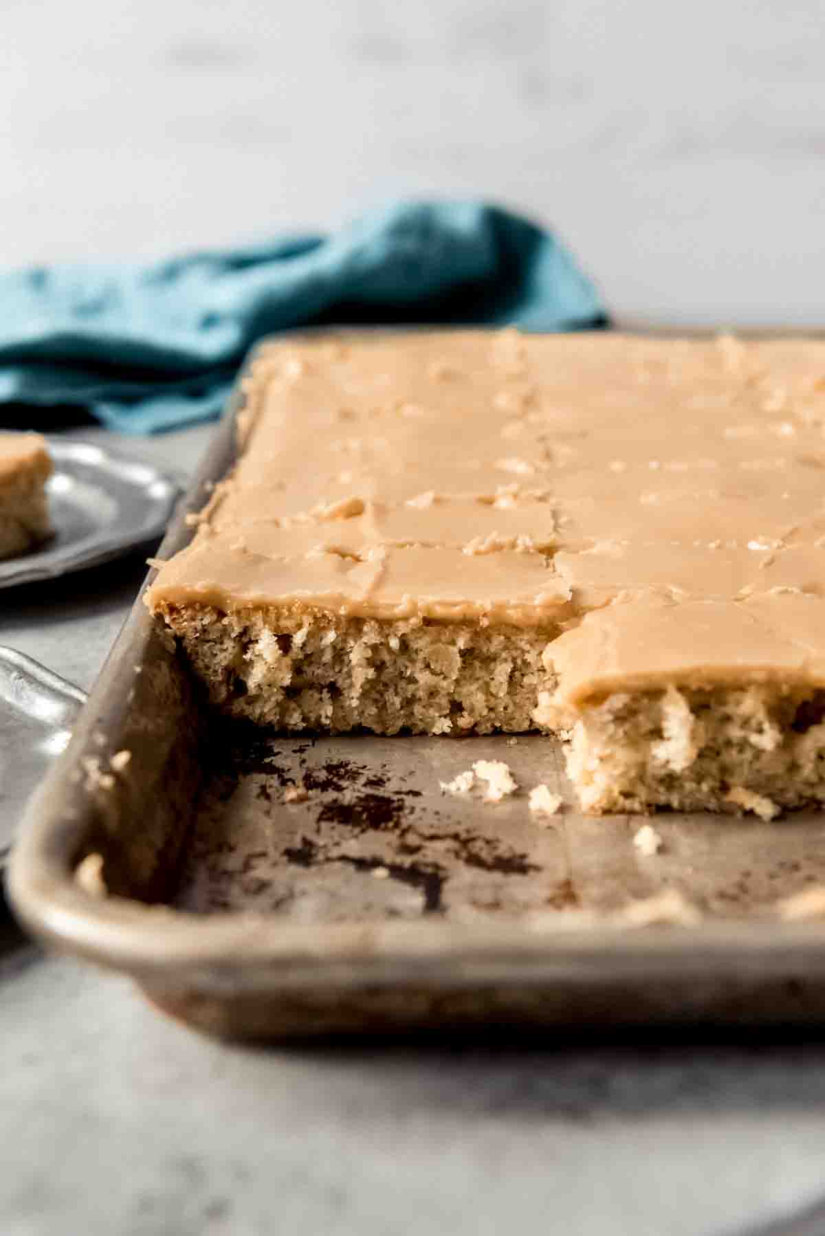 A side image of banana sheet cake covered in penuche frosting.