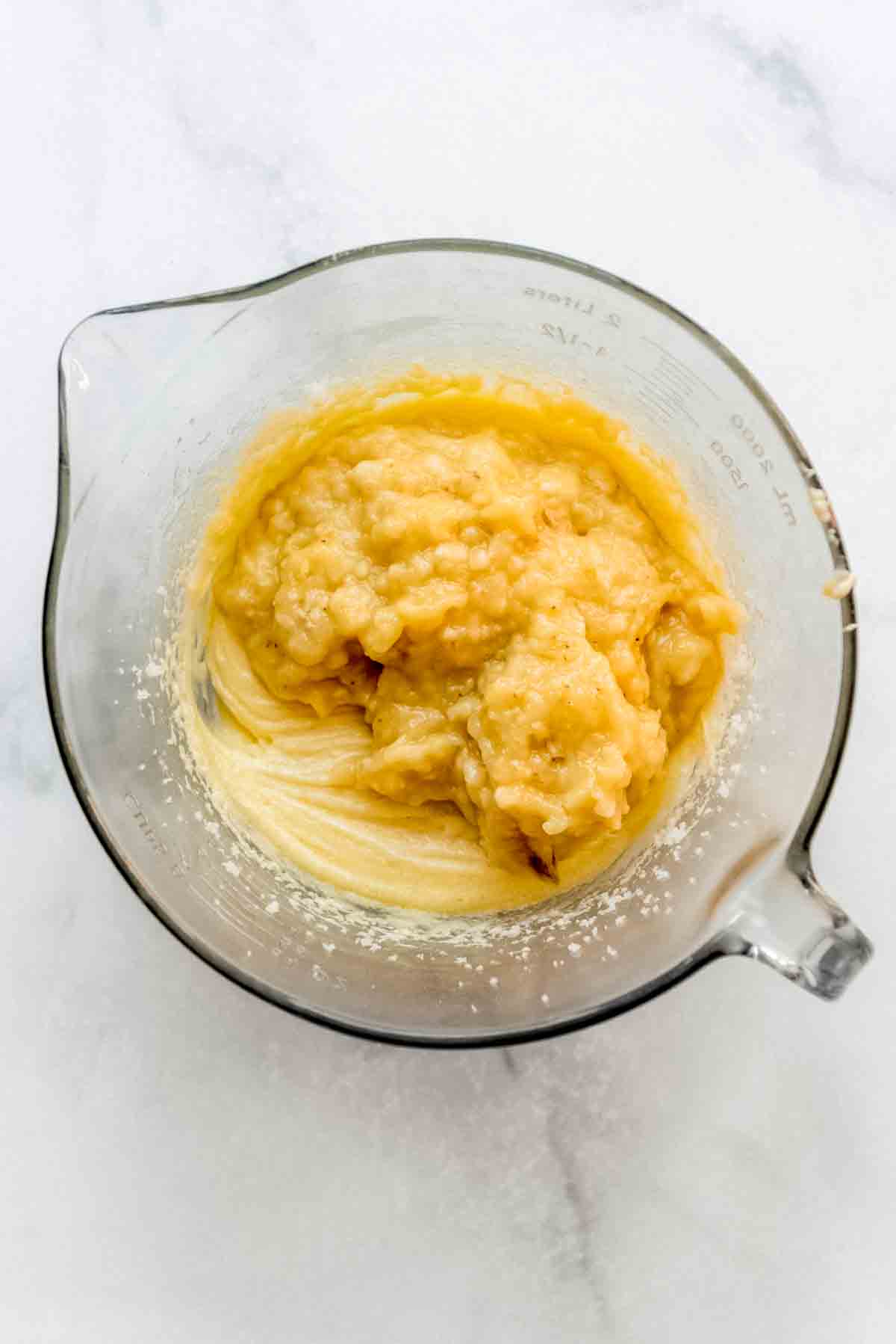 Mashed bananas have been added to the mixed ingredients. 