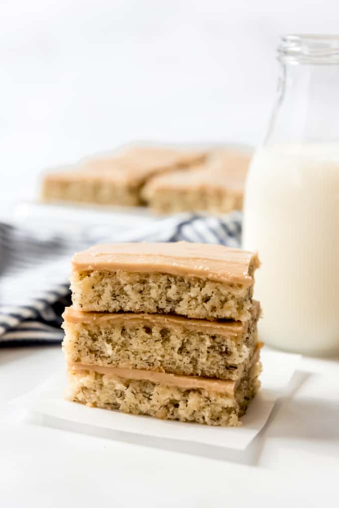 three banana bars with penuche frosting stacked on top of each other