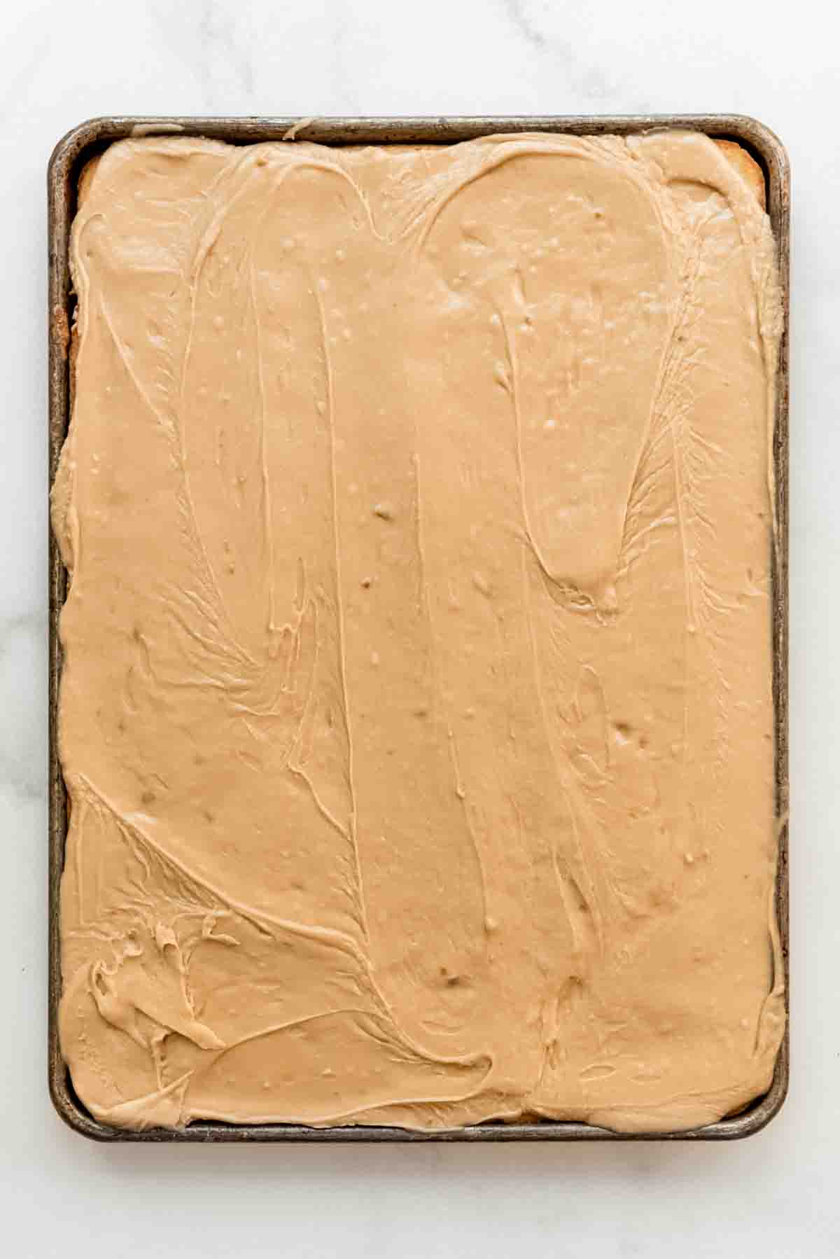 A banana sheet cake covered in penuche frosting.