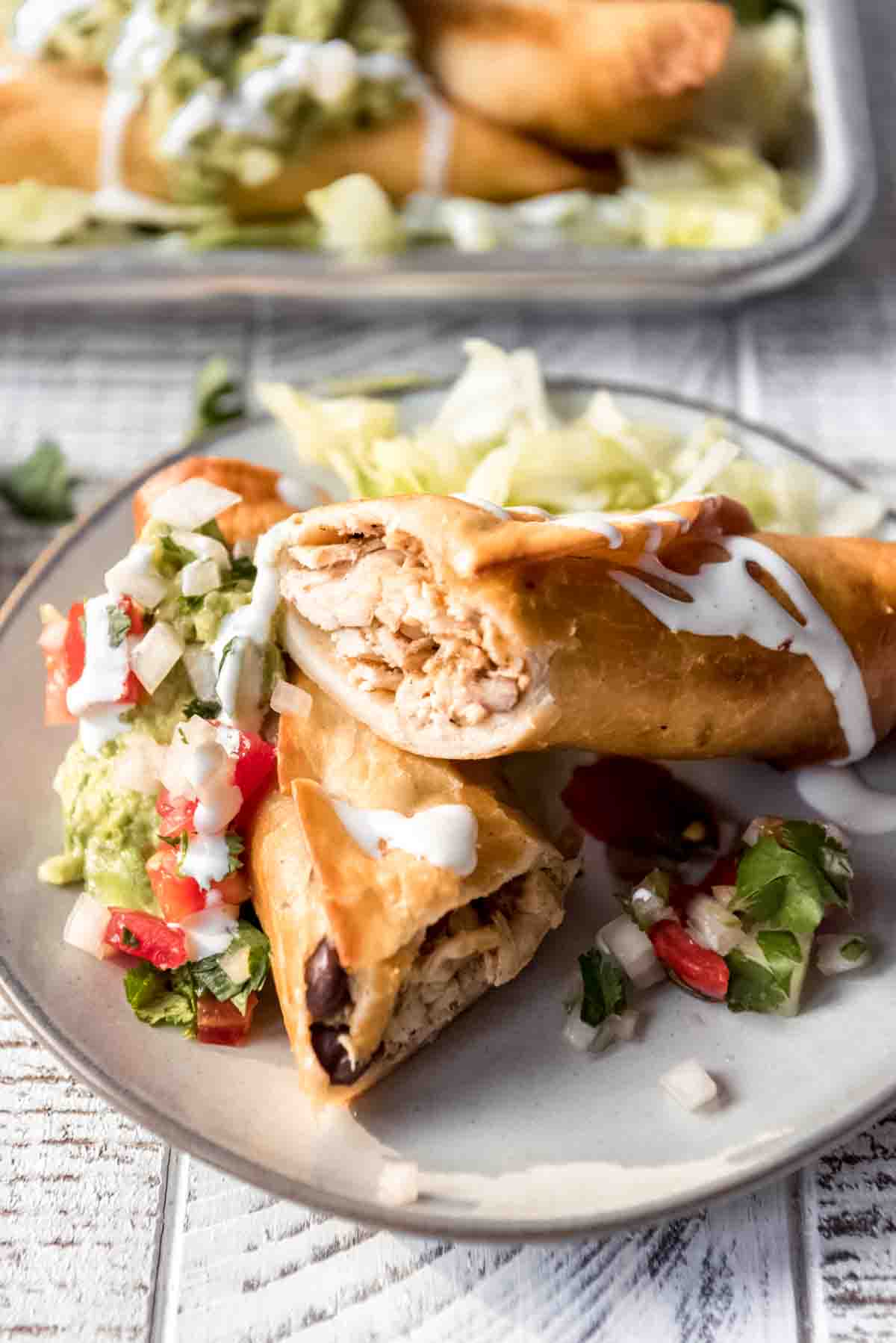 Appetizer sized flautas on a plate.