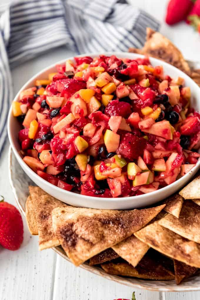 a bowl of fruit salsa with cinnamon chips on the side