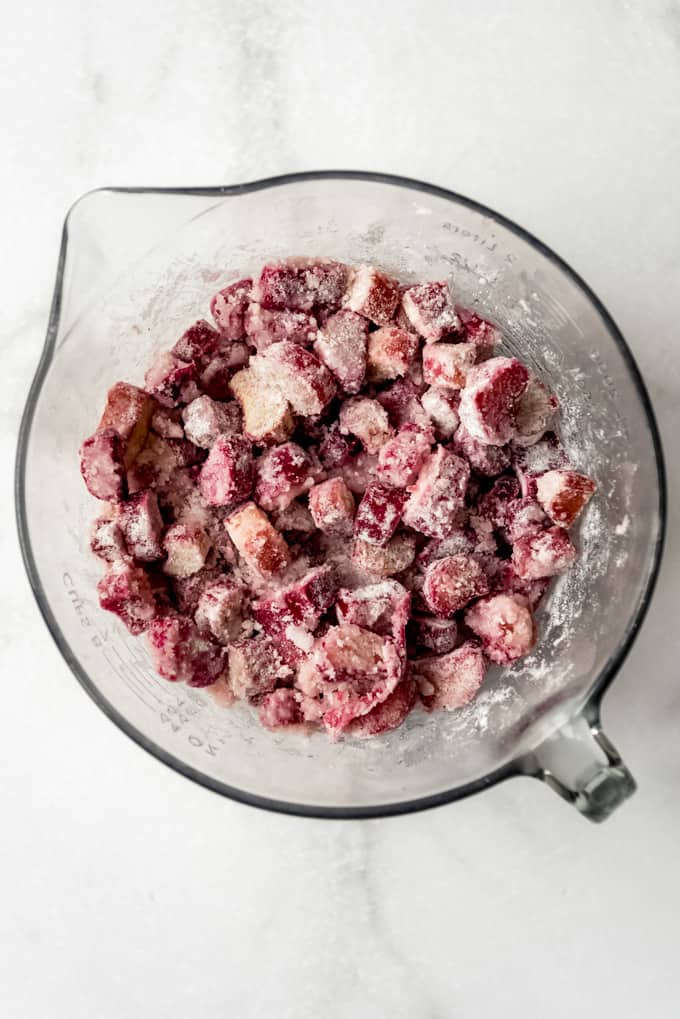fresh rhubarb chopped up and mixed with sugar and flour in a large mixing bowl to make the rhubarb pie filling
