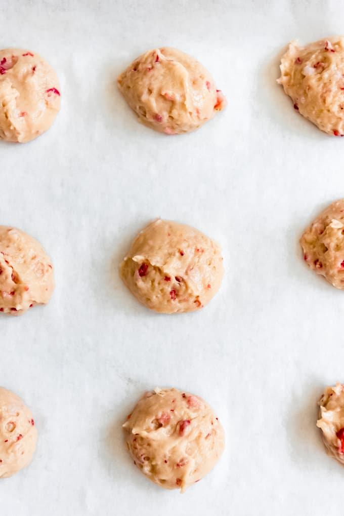 strawberry whoopie pie batter scooped onto a parchment lined baking sheet