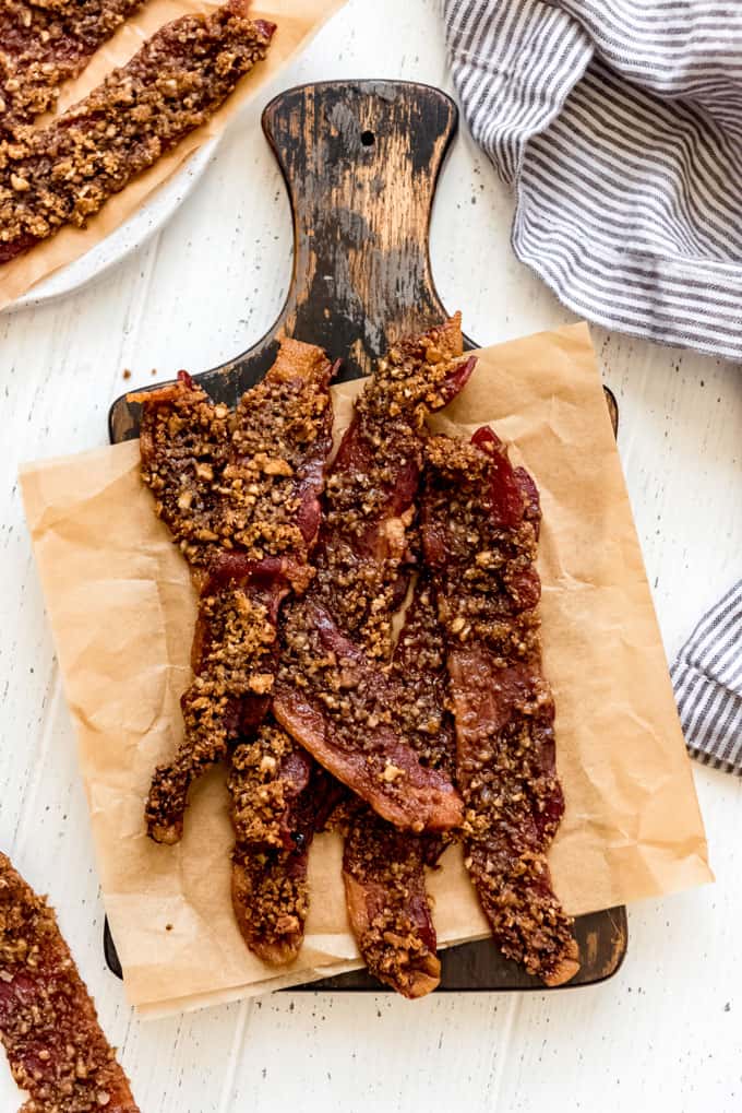 candied bacon on cutting board and dish towel