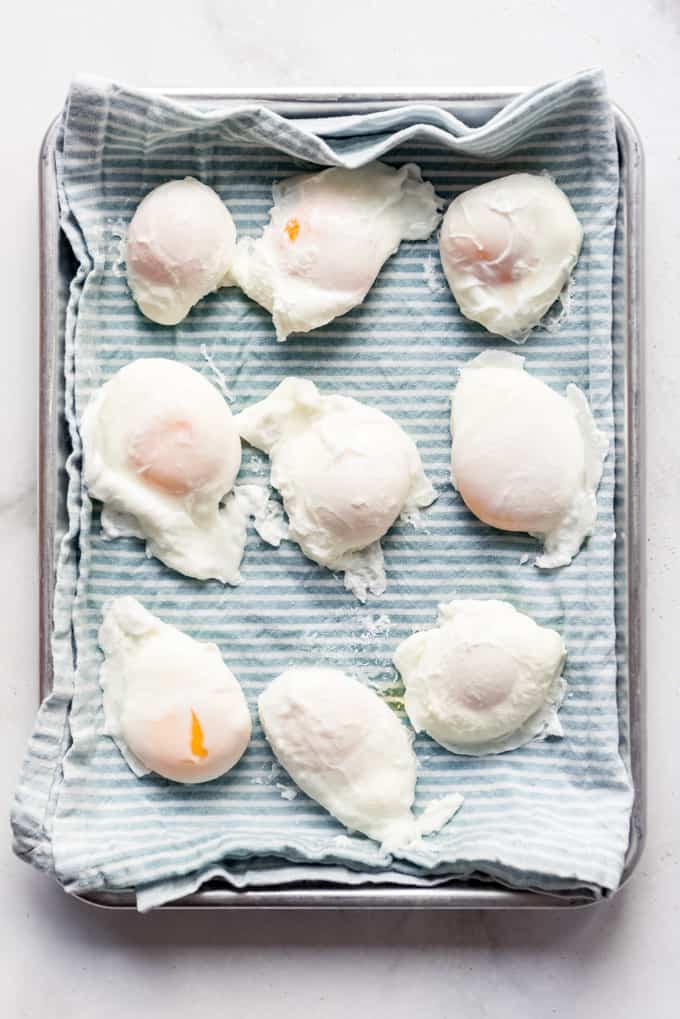 poached eggs on dish towel on baking sheet