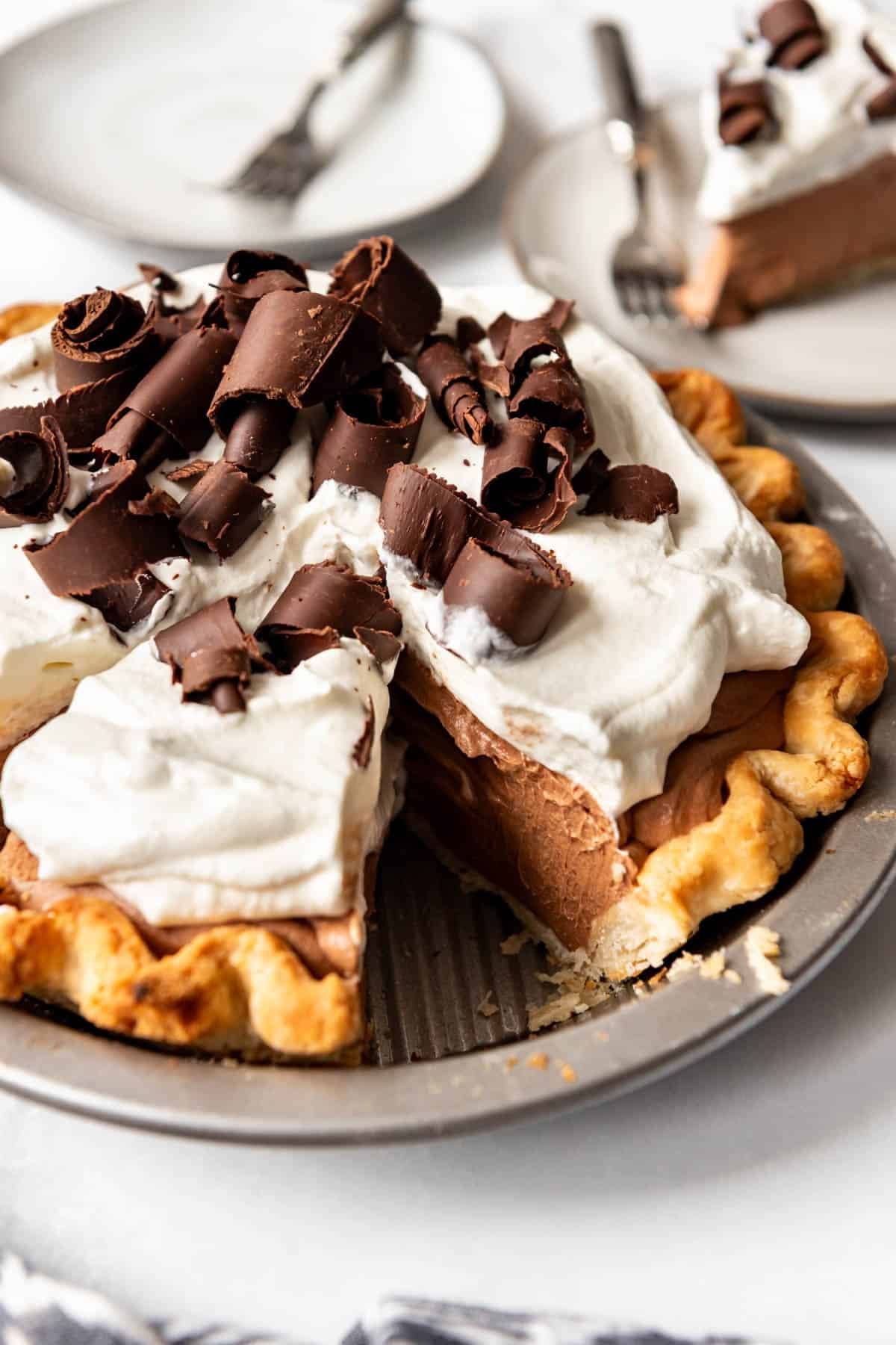 A homemade french silk pie with whipped cream on top.