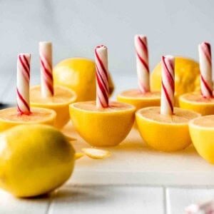 Halved lemons with peppermint sticks stuck in them.