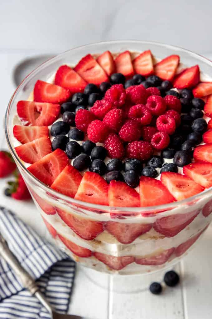 a patriotic berry trifle made with angel food cake, vanilla pudding, homemade whipped cream, and fresh berries