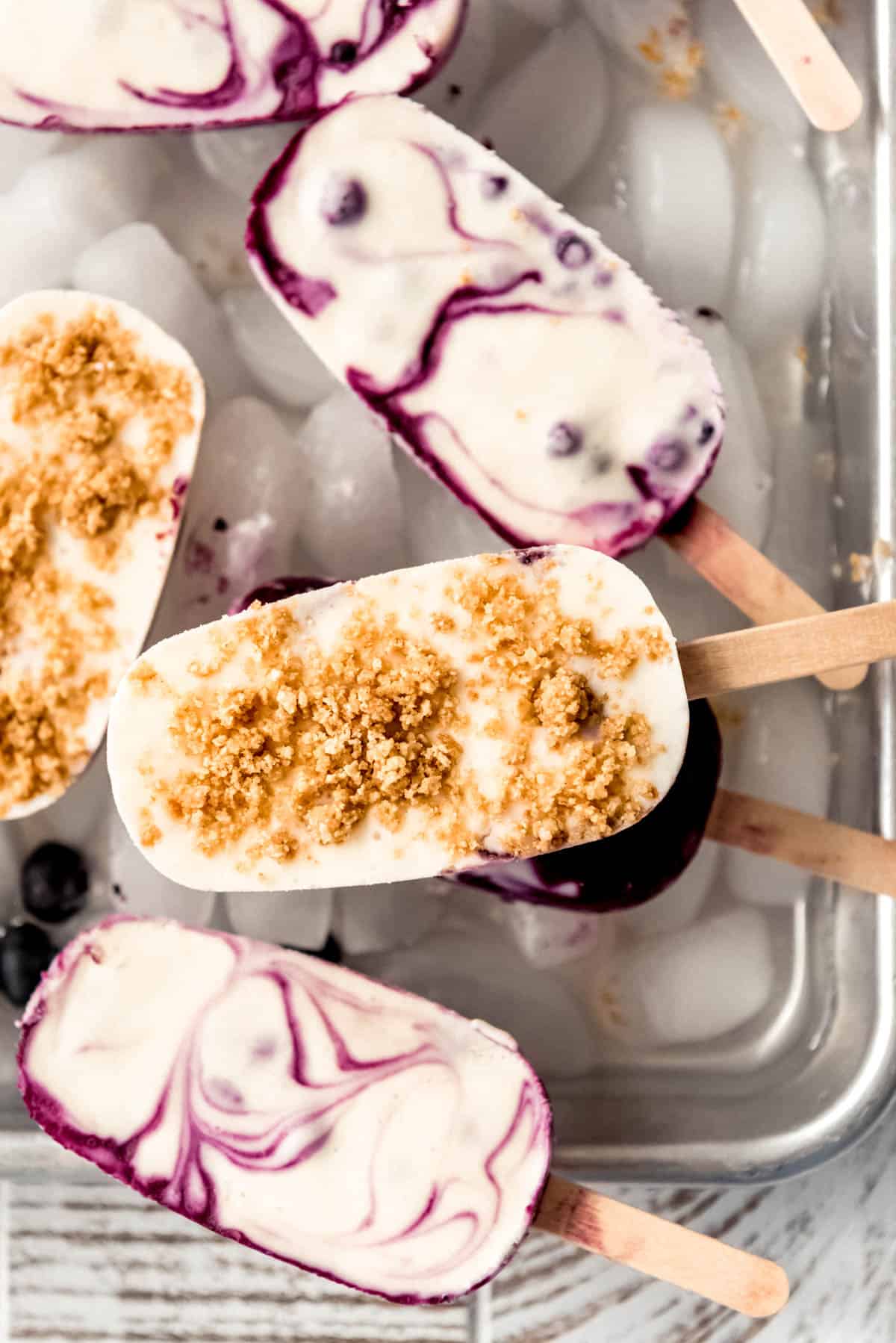 creamy swirled blueberry cheesecake homemade popsicles on ice