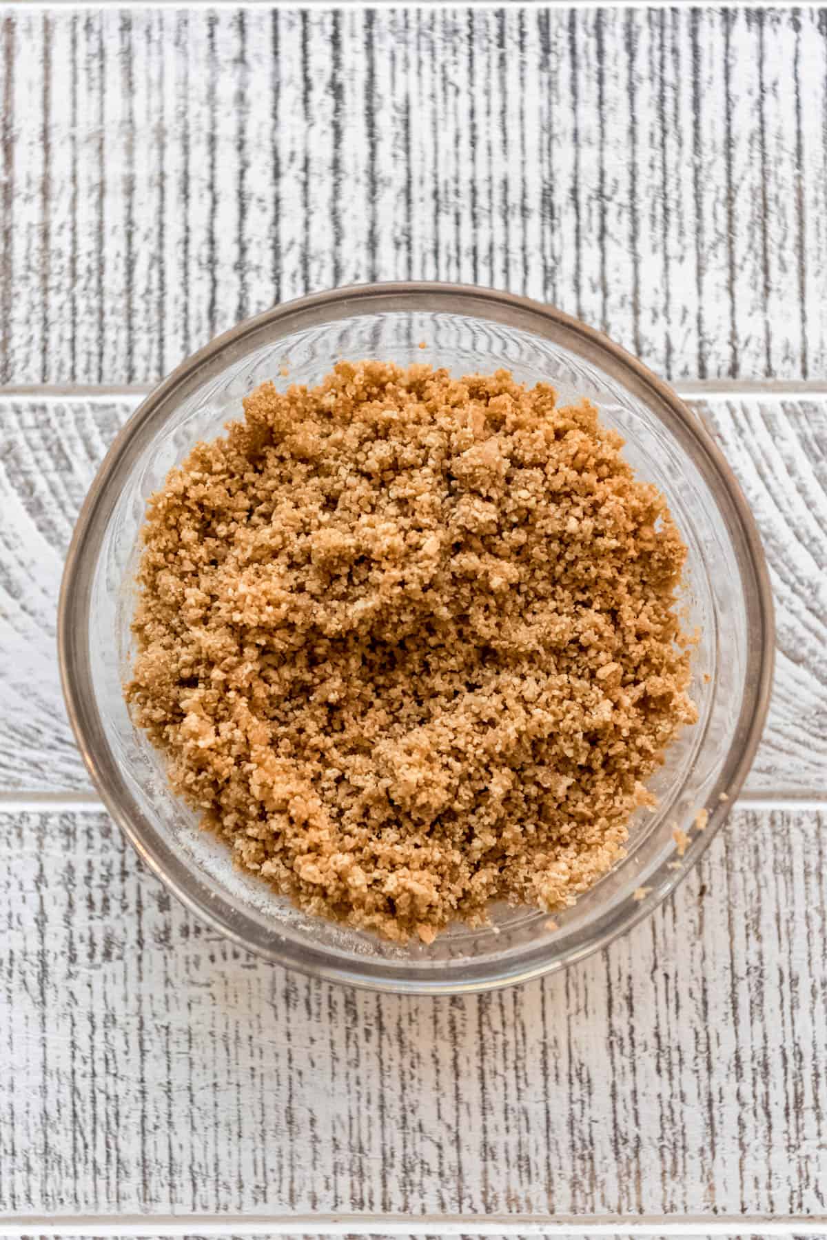 crushed graham crackers mixed with butter in a bowl