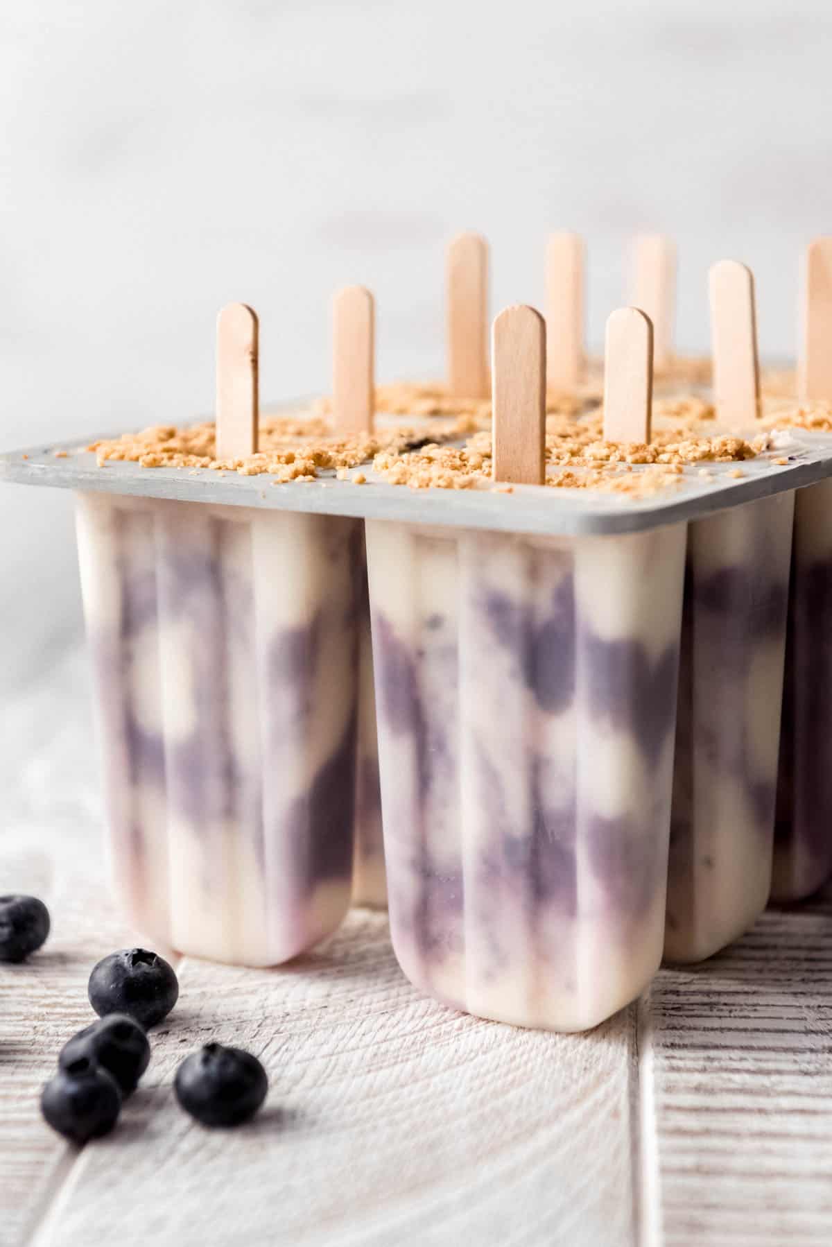 blueberry cheesecake popsicles in a popsicle mold