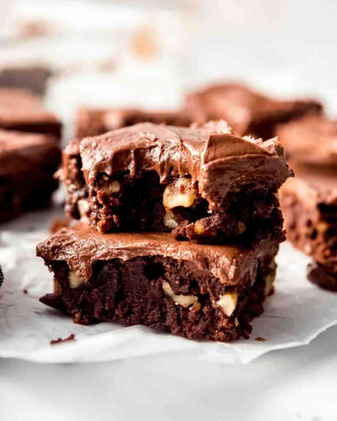 Stacked brownies with chocolate frosting.