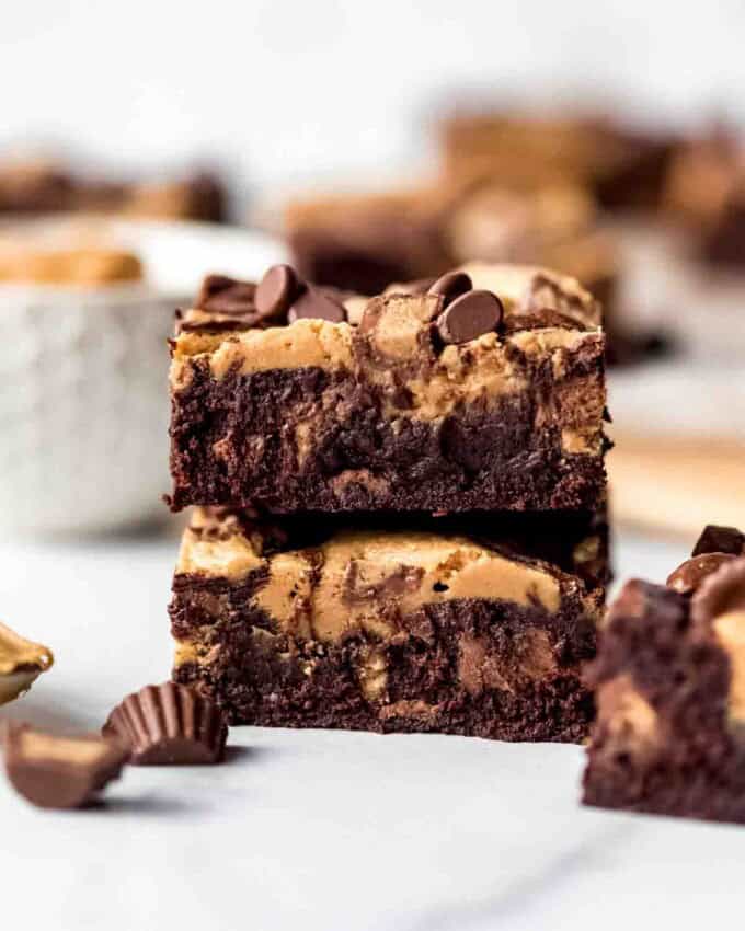 Individual slices of Peanut Butter Swirl Brownies on parchment paper, overhead shot.