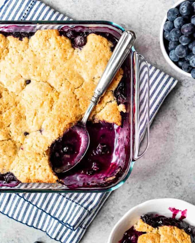 Old-fashioned blueberry cobbler is served into a small bowl.