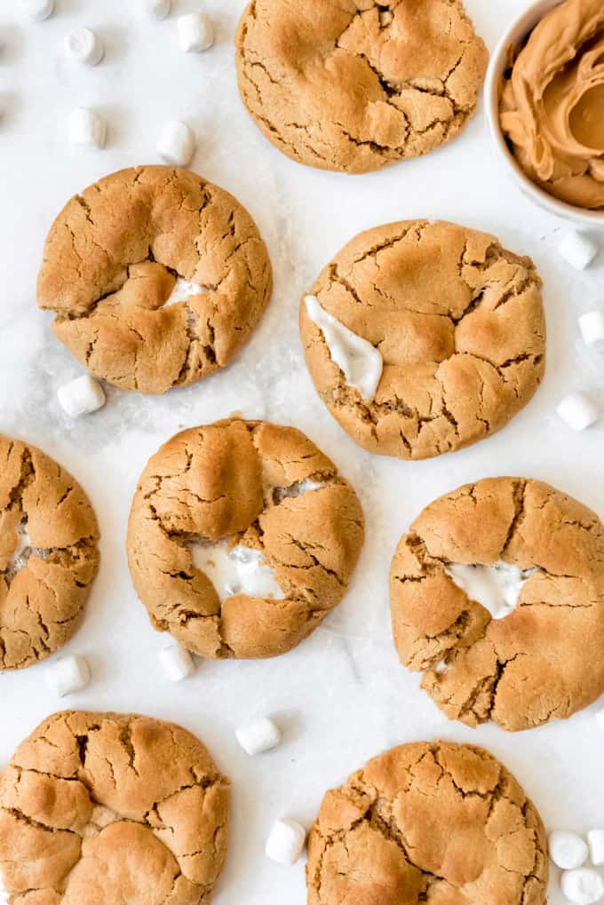 marshmallow stuffed peanut butter cookies on a white surface
