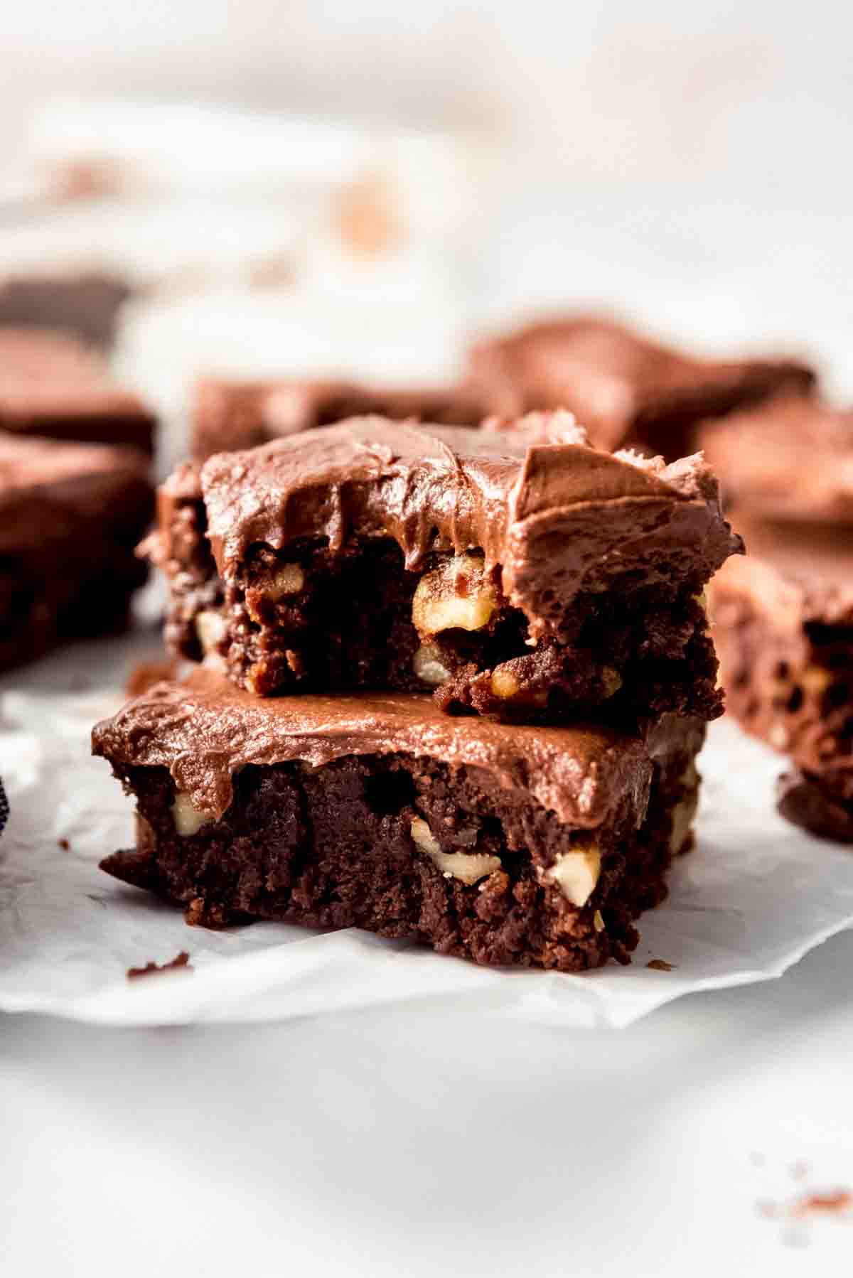 Stacked brownies with chocolate frosting.