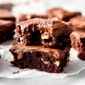 Stacked brownies with chocolate frosting.