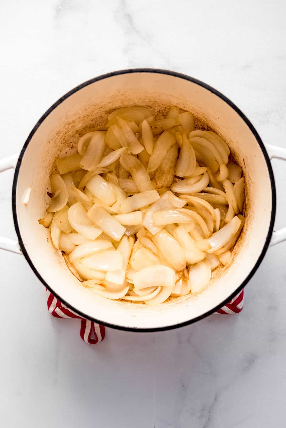 Overhead view of a pan with sliced onions.  