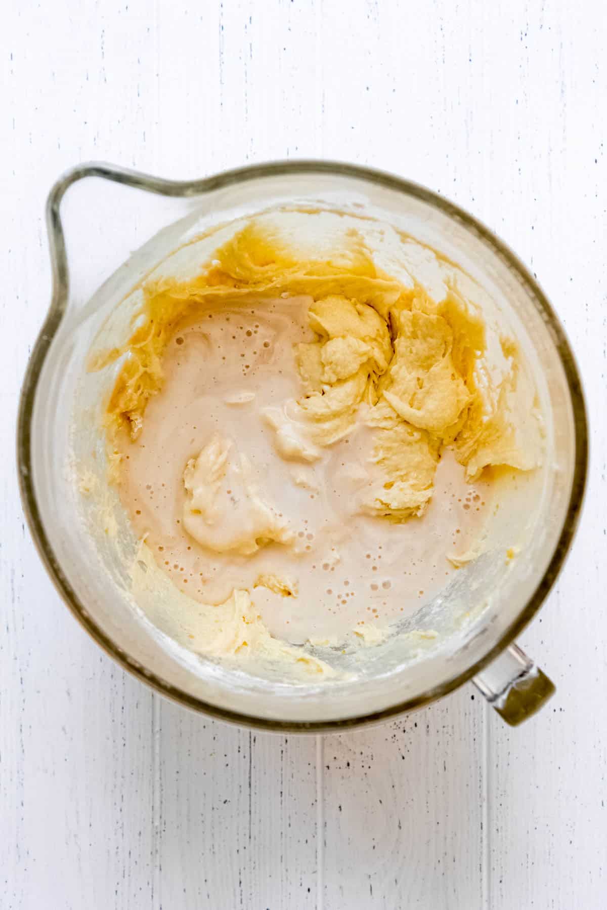 Wet ingredients are added to the lemon cake batter. 