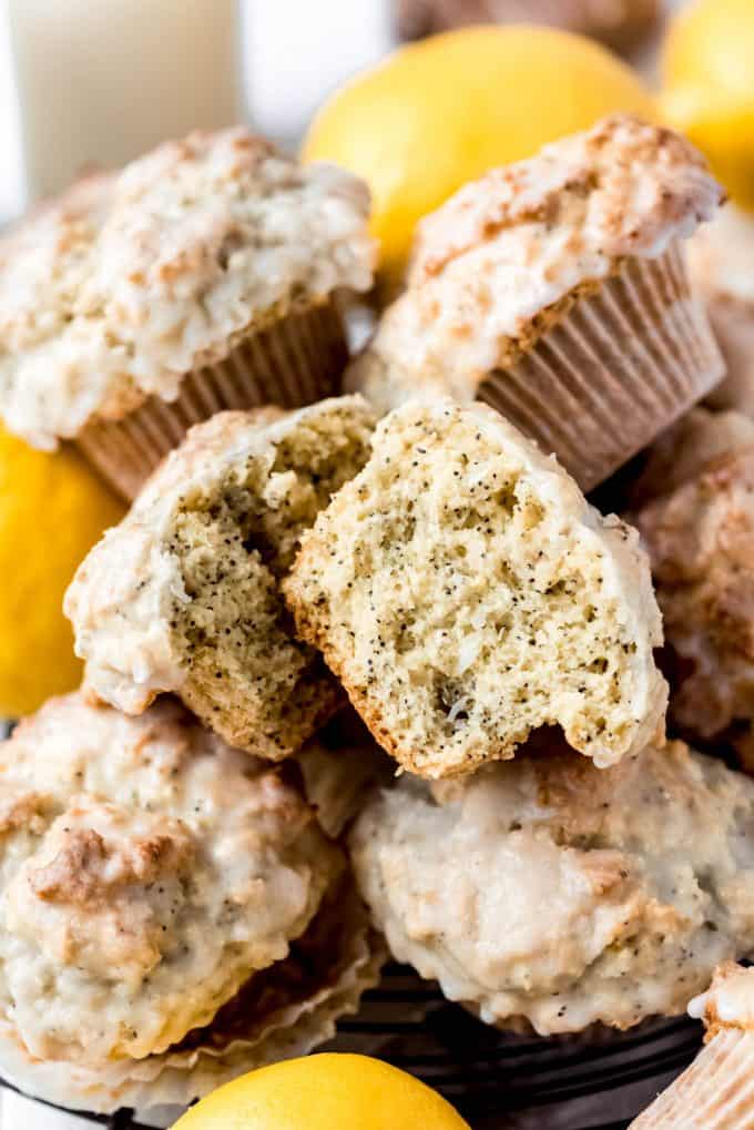 a moist lemon poppy seed muffin split open with more muffins around it