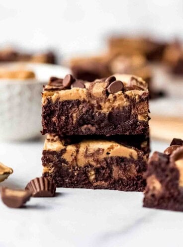 Individual slices of Peanut Butter Swirl Brownies on parchment paper, overhead shot.