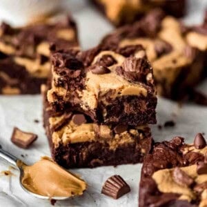 Two Peanut Butter Swirl Brownies stacked on top of each other, bite missing from one brownie.